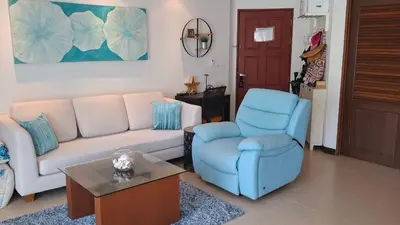 a living room with a couch and a chair at One bed Apartment Nai Yang in Nai Yang Beach