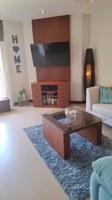 a living room with a couch and a coffee table at One bed Apartment Nai Yang in Nai Yang Beach