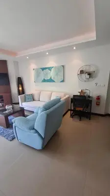 a living room with a couch and a piano at One bed Apartment Nai Yang in Nai Yang Beach