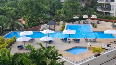 an overhead view of a swimming pool with umbrellas and chairs at One bed Apartment Nai Yang in Nai Yang Beach