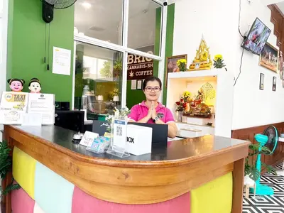 a woman sitting at a counter in a restaurant at Arisa Hotel Patong Beach in Patong Beach