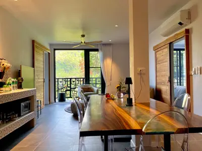 a kitchen and dining room with a table and chairs at Kata Luxury Apartment Matriochka 2BR En-suite in Kata Beach