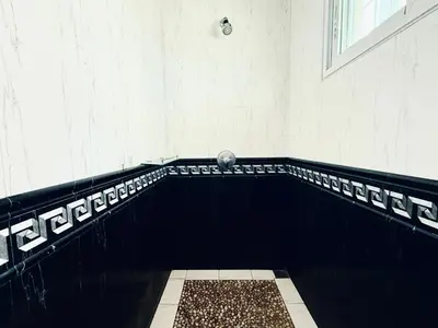 a bathroom with a black and white tile floor at Chuan Pool Villa Rawai Phuket in Rawai Beach