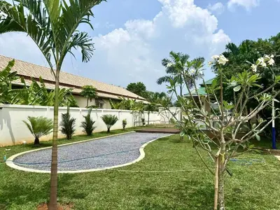 a garden with a gravel driveway and a house at Chuan Pool Villa Rawai Phuket in Rawai Beach
