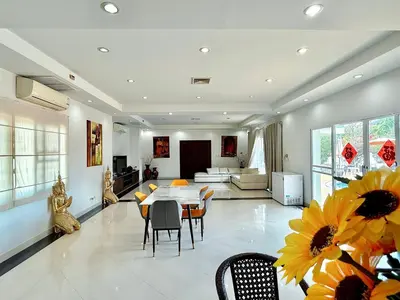 a dining room and living room with a table and chairs at Chuan Pool Villa Rawai Phuket in Rawai Beach