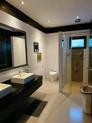 a bathroom with two sinks and a toilet and a mirror at Luxury Pool Villa Nai Harn in Ban Saiyuan (1)