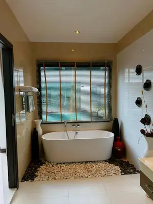 a bath tub in a bathroom with a window at Luxury Pool Villa Nai Harn in Ban Saiyuan (1)