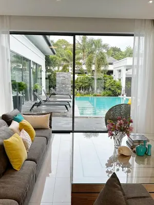 a living room with a couch and a pool at Luxury Pool Villa Nai Harn in Ban Saiyuan (1)