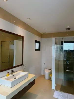 a bathroom with a sink and a shower and a mirror at Luxury Pool Villa Nai Harn in Ban Saiyuan (1)