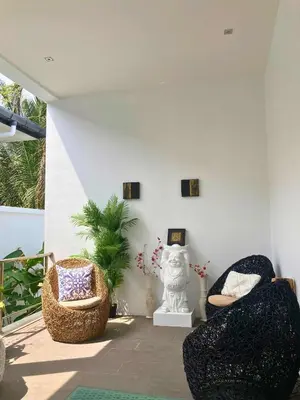 a living room with two chairs and a statue at Luxury Pool Villa Nai Harn in Ban Saiyuan (1)