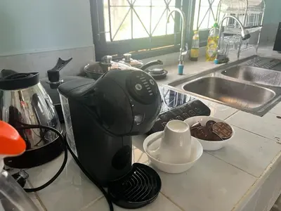 a coffee maker on a counter next to a sink at Chill Apartment Lake View in Rawai Beach