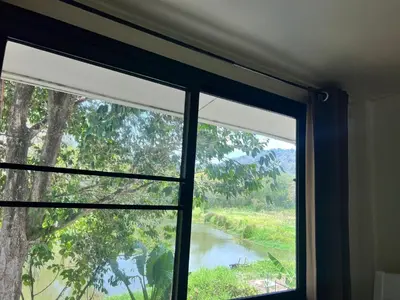 a window in a room with a view of a river at Chill Apartment Lake View in Rawai Beach