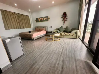a living room with a bed and a couch at Chuan SeaFront Villa Rawai Phuket in Rawai Beach