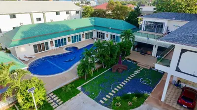 an aerial view of a house with a swimming pool at Chuan SeaFront Villa Rawai Phuket in Rawai Beach