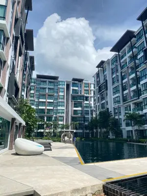 a large apartment complex with a swimming pool and buildings at Royal Lee Phuket Condominium AirportB in Ban Bo Han