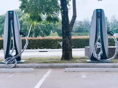 a pair of swings in a park with a tree at Royal Lee Phuket Condominium AirportB in Ban Bo Han