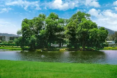 a lake with a tree and a sign that reads royal lease at Royal Lee Phuket Condominium AirportB in Ban Bo Han