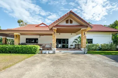 a house with a gate and a porch at Lantern Villa Private Pool Villa in Ban Klang
