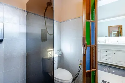 a bathroom with a toilet and a shower at Lantern Villa Private Pool Villa in Ban Klang
