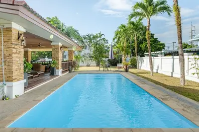 a swimming pool in the backyard of a house at Lantern Villa Private Pool Villa in Ban Klang