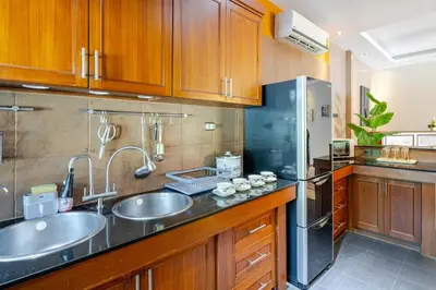 a kitchen with two sinks and a refrigerator at Lantern Villa Private Pool Villa in Ban Klang