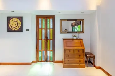 a room with a dresser and a mirror at Lantern Villa Private Pool Villa in Ban Klang