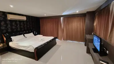 a bedroom with a bed and a flat screen tv at Bay Shore Ocean View by Get A Rent Phuket in Patong Beach