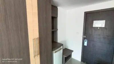 a bathroom with a wooden door and a stair case at Bay Shore Ocean View by Get A Rent Phuket in Patong Beach