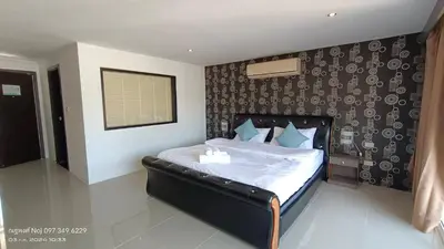 a bedroom with a large bed with a black headboard at Bay Shore Ocean View by Get A Rent Phuket in Patong Beach