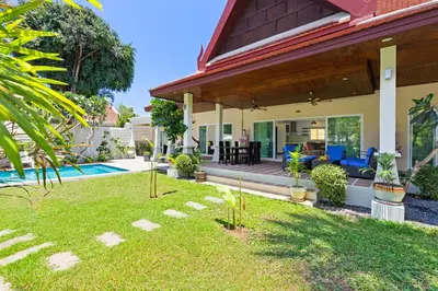 a home with a backyard with a pool and a house at 3BR Villa Barnabé with Lush Garden in Rawai Beach