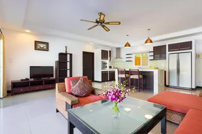 a living room with a couch and a table at 3BR Villa Barnabé with Lush Garden in Rawai Beach