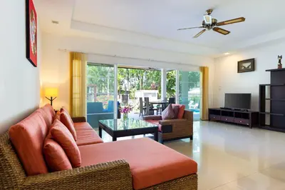 a living room with a couch and a table at 3BR Villa Barnabé with Lush Garden in Rawai Beach