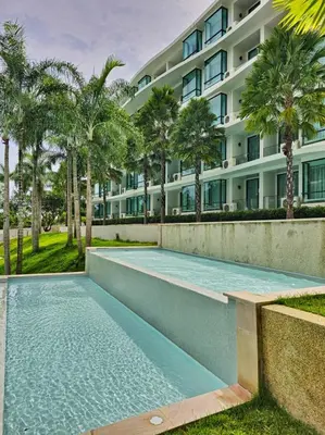 a swimming pool in front of a building at New Studio in 5 Hotel 500m to Rawai beach in Phuket Town