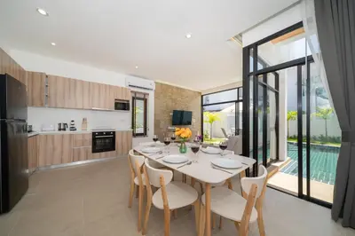 a kitchen and dining room with a table and chairs at Goldena Twin Project - 3 Bedrooms Pool Villa in Kamala Beach