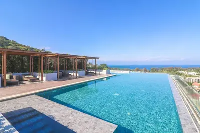 a swimming pool with a view of the ocean at 2-Bedrooms Seaview Suite in Surin Beach in Surin Beach