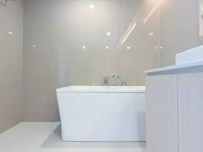 a white bathroom with a sink and a shower at Duplex Cala 1BR FamilyPoolsGym Shuttle in Rawai Beach