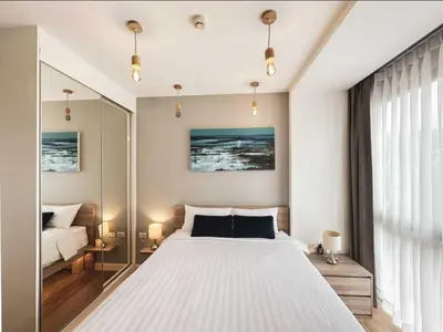 a bedroom with a large white bed and a window at Diamond Resort in Bang Tao Beach