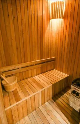 a wooden sauna with a bench in the middle at Diamond Resort in Bang Tao Beach