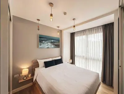 a bedroom with a large bed and a window at Diamond Resort in Bang Tao Beach