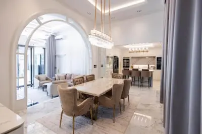 a dining room and living room with a table and chairs at Gold Chariot in Laguna Phuket