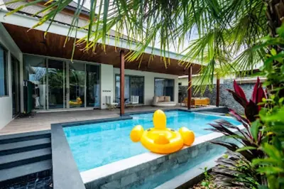 a pool with a rubber duck in the middle of a house at Gold Chariot in Laguna Phuket