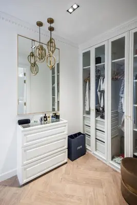 a dressing room with white cabinets and a mirror at Gold Chariot in Laguna Phuket