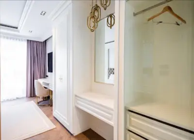 a dressing room with a mirror and a sink at Gold Chariot in Laguna Phuket