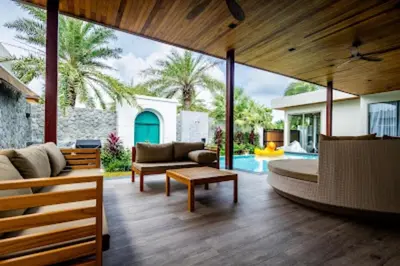a living room with a couch and a table at Gold Chariot in Laguna Phuket