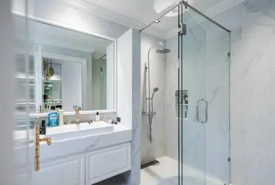 a bathroom with a sink and a glass shower at Gold Chariot in Laguna Phuket