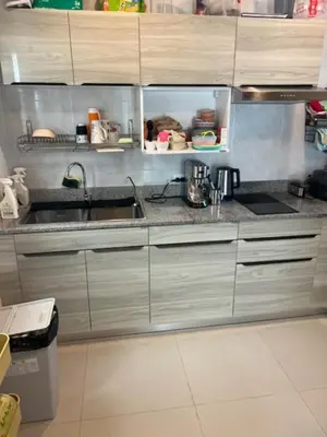 a kitchen with stainless steel cabinets and a sink at Villa PalmSprings in Ban Phak Chit