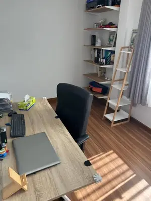 a desk with a laptop and a chair in a room at Villa PalmSprings in Ban Phak Chit
