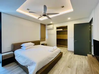a bedroom with a bed with a ceiling fan at 3bdr Pool Villa Laguna Park-2 in Ban Phru Champa