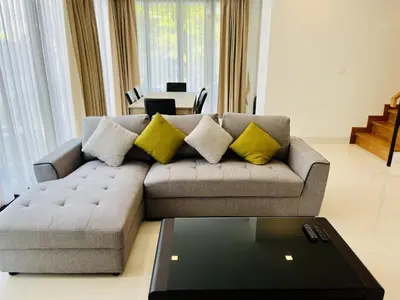 a living room with a couch with yellow pillows at 3bdr Pool Villa Laguna Park-2 in Ban Phru Champa