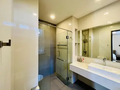a bathroom with a glass shower and a sink at 3bdr Pool Villa Laguna Park-2 in Ban Phru Champa